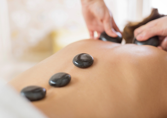 A having a hot stone massage at home
