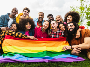A group of LGBTQ friends holding a pride flag in Los Angeles