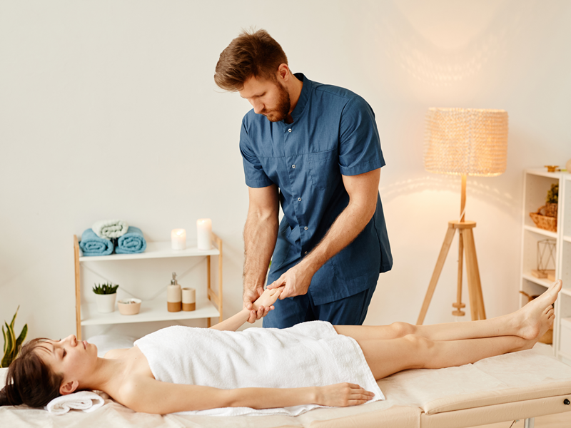 A male massage therapist giving a woman a massage at her home in Las Vegas