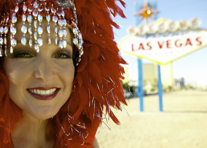 A Las Vegas Showgirl by a Las Vegas sign