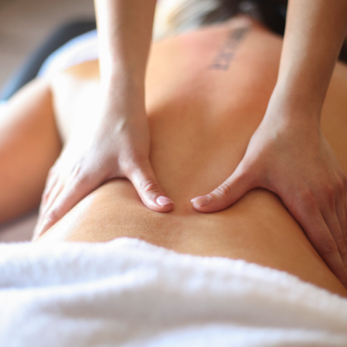 A woman with fibromyalgia receiving a massage in her home
