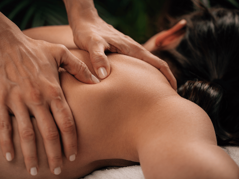 A woman from Los Angeles getting an on-demand deep tissue massage at her home in Las Vegas after doing a deep tissue massage near me search